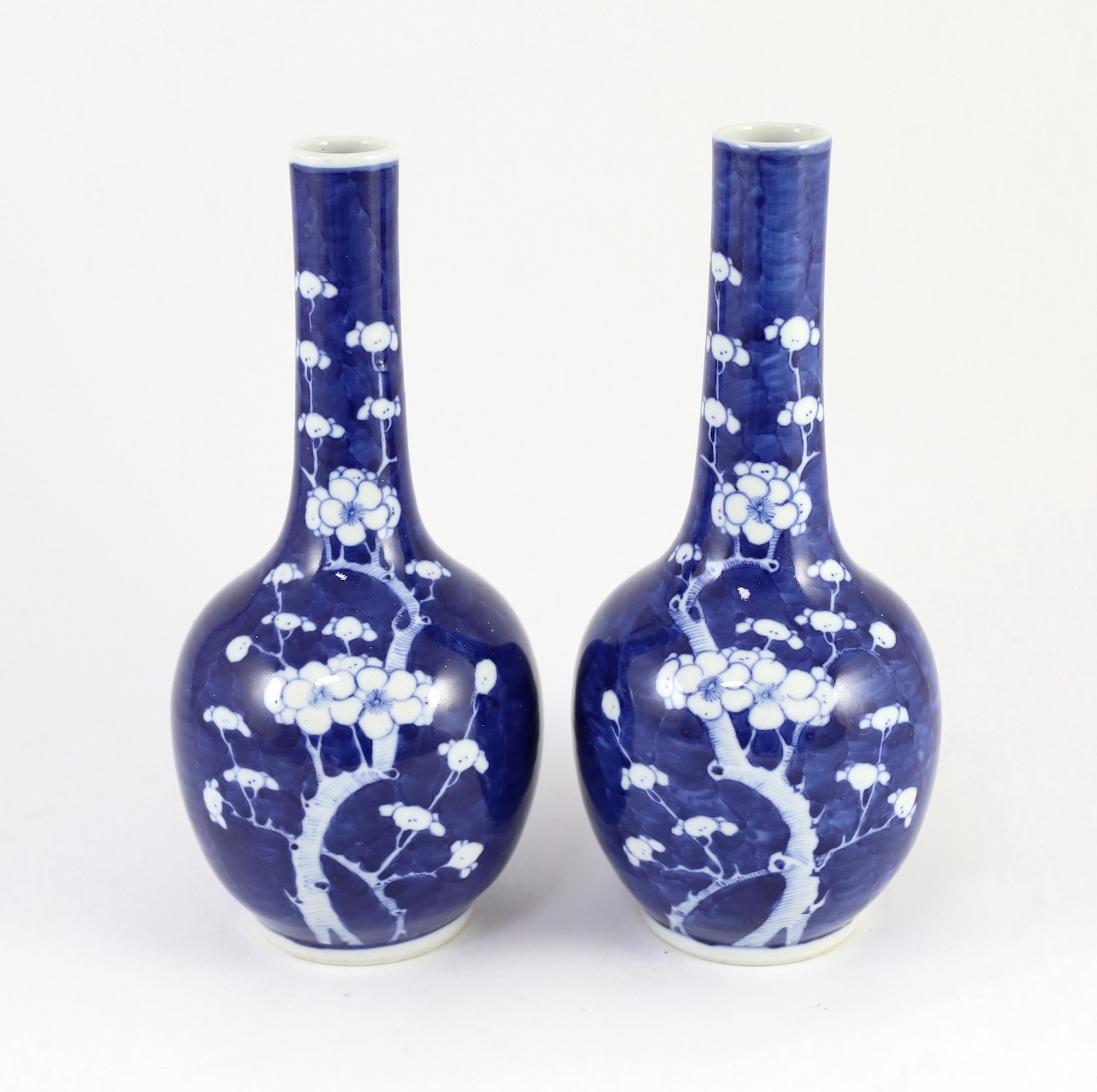 A pair of Chinese blue and white prunus bottle vases, early 20th century, 26cm
